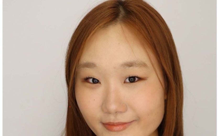 Aubrey Im is smiling at the camera. She has a black blazer over a white shirt