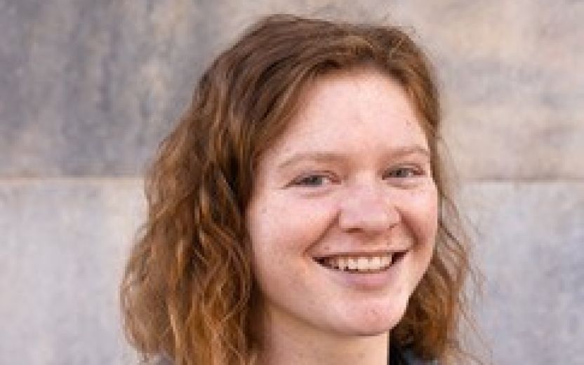 Ashlyn is smiling at the camera and standing outside