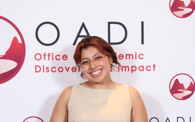 Maritza Reyes is smiling with her award from the OADI Honors award show