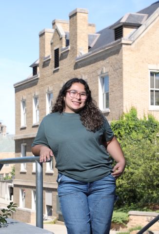 Jailyn Looir is smiling at the camera. She is outside on a beautiful day on Cornell campus