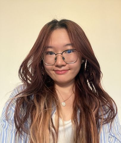 Hanni Yang is smiling at the camera