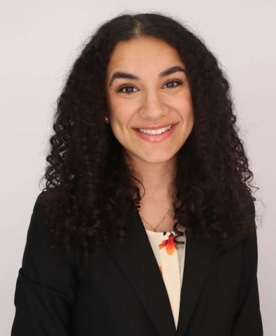 Chery Abdelmassih is smiling at the camera. She has on proffesional clothes