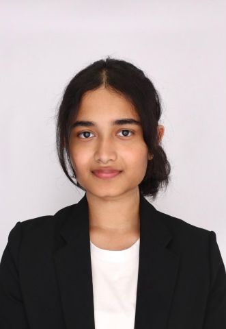 Soha Khan is looking at the camera. She has on professional clothes