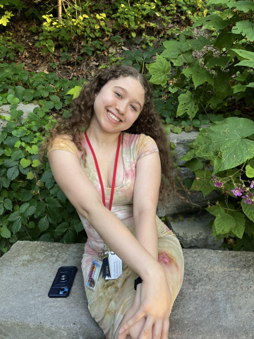 Kaelin Lamberson is sitting down outside and smiling at the camera.