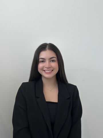 Marianna Ruggiero is smiling at the camera. She has on professional attire