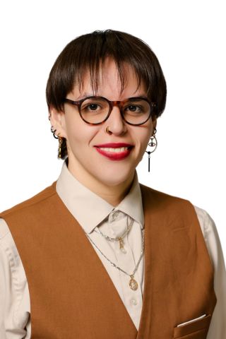 Monica Cornejo is smiling at the camera, wearing professional clothes