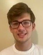 Alex is smiling at the camera