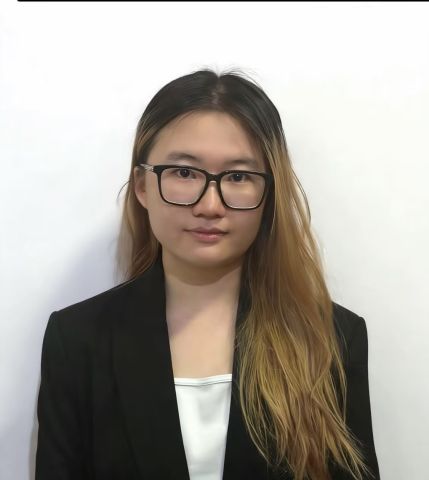 Hanni is looking at the camera in professional clothes