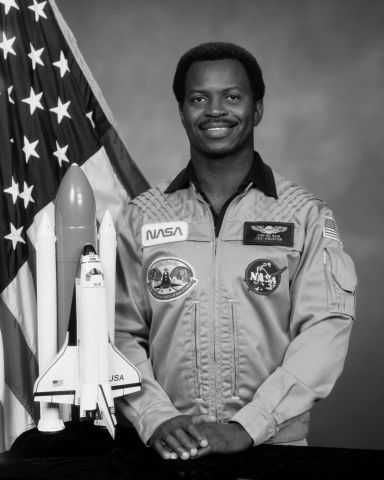 Ronald McNair in his astronaut suit smiling at the camera