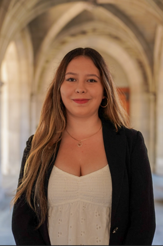 Katherine Gramajo is smiling at the camera. She is outside and wearing professional clothes