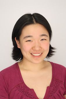 Carolyn Ma is smiling at the camera. She has on a fuchsia-colored shirt